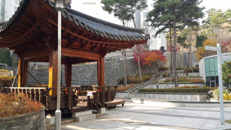 단지 중앙에는 주민 휴게시설이 넓게 자리하고 있으며 주변으로 조형물과 조경이 어우러져 있습니다